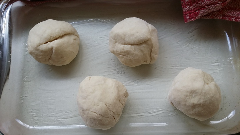 Dough divided into four balls before rising